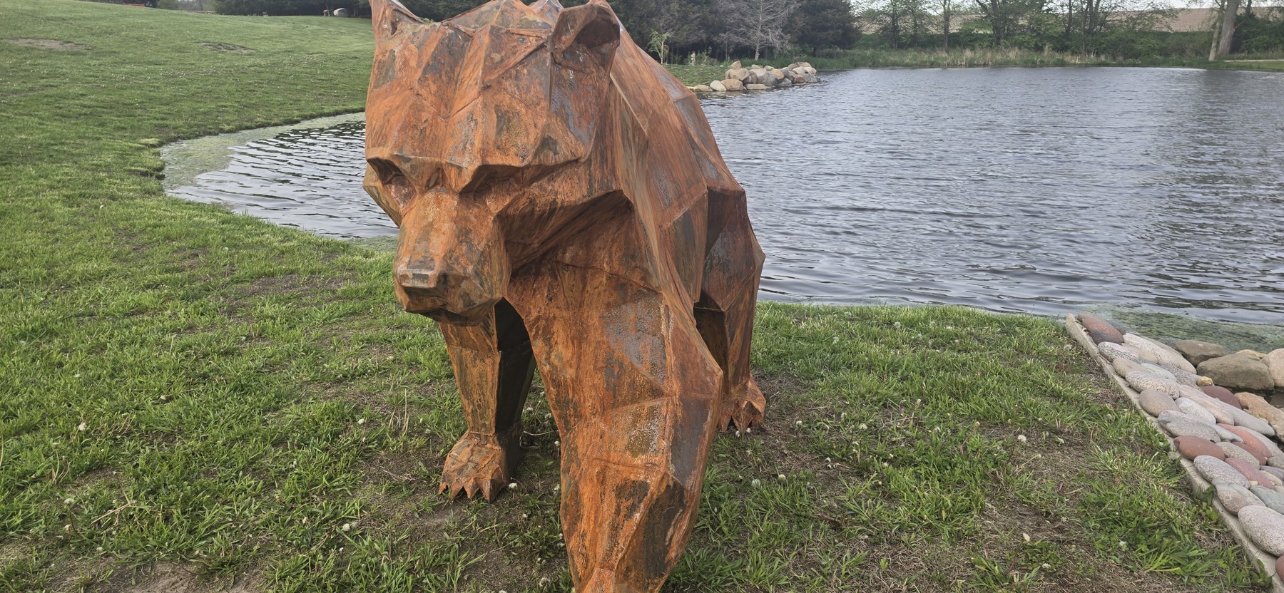 Grizzly Bear facing the pond path