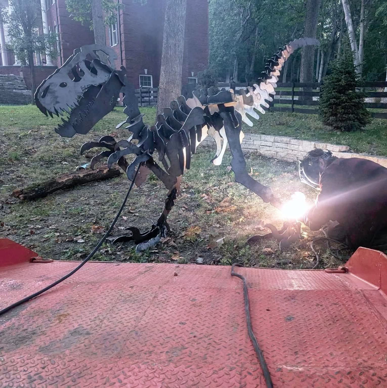 Welding the dinosaur outdoors